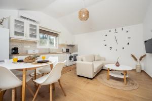a kitchen and living room with a table and chairs at Destinys Village II in Zakynthos +14 photos
