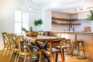 a kitchen and dining room with a wooden table and chairs at Sunshine Daydream in Folly Beach