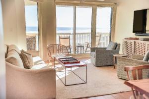 a living room with a view of the ocean at Sunshine Daydream in Folly Beach
