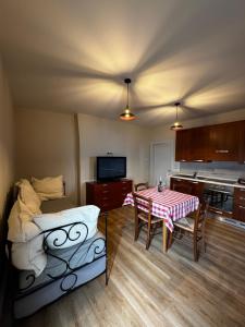 a room with a bed and a table and a kitchen at Cascina Buren in Brescia