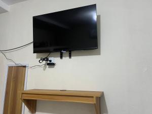 a flat screen tv hanging on a wall at Suite El Ángel #7 in Tuxtla Gutiérrez