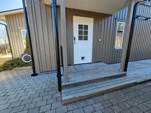 a house with a porch with a white door at Fahléns 10 Villa in Jomala +15 photos