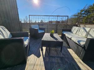 a patio with two couches and a table and a couch at Fahléns 10 Villa in Jomala