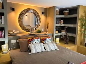 a bedroom with a bed with a large mirror at Seven Elements Appart in La Gaulette