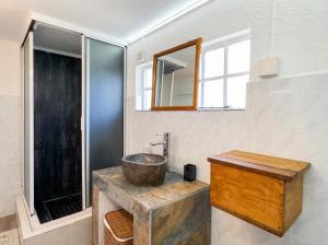 a bathroom with a sink and a mirror at Seven Elements Appart in La Gaulette +2 photos