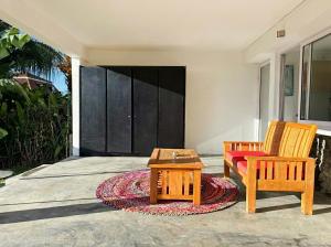 a patio with two chairs and a coffee table at Seven Elements Appart in La Gaulette