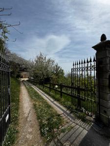 a fence next to a dirt road next to a field at Cascina Buren in Brescia
