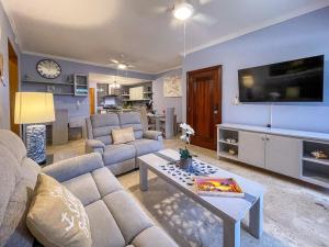 a living room with a couch and a table at 1 min walk beach,bars,grocery in Punta Cana