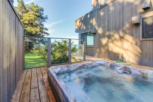 a hot tub on the deck of a house at Webb House in Valley Crossing