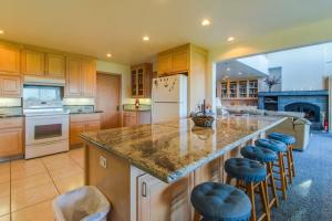 a kitchen with a large island with bar stools at Webb House in Valley Crossing