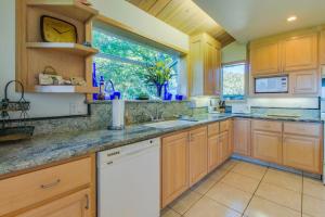 a large kitchen with wooden cabinets and a window at Webb House in Valley Crossing