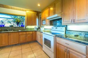 a large kitchen with wooden cabinets and white appliances at Webb House in Valley Crossing +25 photos
