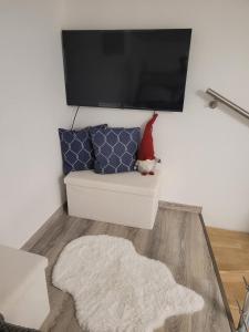 a living room with a couch and a flat screen tv at BEM MINI STUDiO in Budapest