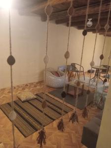 a room with a hanging bed with a rug at Small House Pisac in Pisac