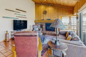 a living room with a couch and a fireplace at Windrow Retreat in Sea Ranch