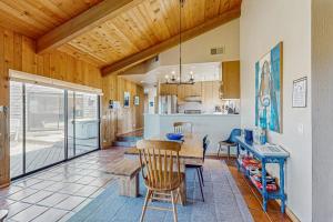 a kitchen with a wooden ceiling and a table and chairs at Windrow Retreat in Sea Ranch