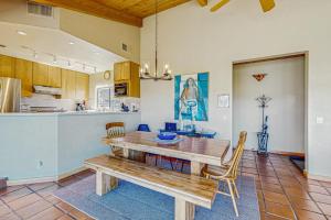 a dining room with a wooden table and a kitchen at Windrow Retreat in Sea Ranch +11 photos
