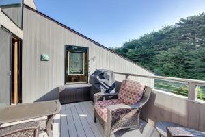 a balcony with two chairs and a table and a window at Prentiss Retreat in Sea Ranch