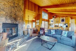 a living room with a couch and a fireplace at Prentiss Retreat in Sea Ranch