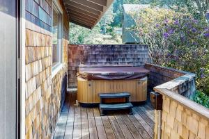 a private deck with a hot tub and a stool at Meyer Getaway in Sea Ranch