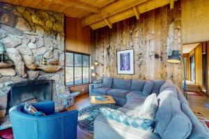 a living room with a couch and a stone wall at Meyer Getaway in Sea Ranch