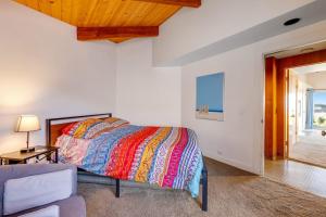 a bedroom with a bed and a couch and a window at Samson Getaway in Sea Ranch