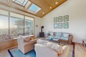 a living room filled with furniture and a large window at Del Mar Meadow in Sea Ranch