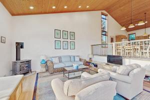 a living room with two couches and a fireplace at Del Mar Meadow in Sea Ranch