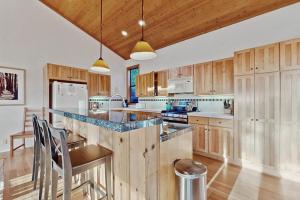 a kitchen with wooden cabinets and a table and chairs at Del Mar Meadow in Sea Ranch