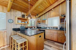 a kitchen with wooden walls and a large counter top at Stoney House in Sea Ranch