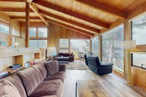 a living room with a couch and a fireplace at Stoney House in Sea Ranch
