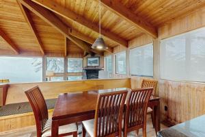 a dining room with a wooden table and chairs at Stoney House in Sea Ranch +25 photos