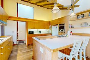 a kitchen with a large white counter top and wooden cabinets at Vista Grande in Sea Ranch