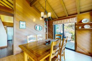 a dining room with a wooden table and chairs at Vista Grande in Sea Ranch +30 photos
