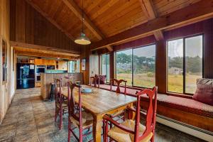 a dining room with a table and chairs and a couch at Norman House in Sea Ranch