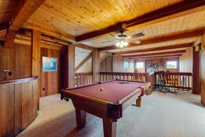 a large room with a pool table in a cabin at Norman House in Sea Ranch