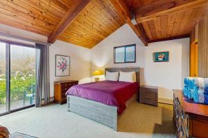 a bedroom with a large bed and a wooden ceiling at Norman House in Sea Ranch +21 photos