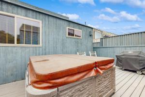 a bed sitting on top of a wooden deck at Ocean Star in Sea Ranch