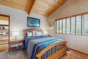 a bedroom with a bed and a wooden ceiling at Ocean Star in Sea Ranch