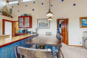 a dining room with a long table with stars on the wall at Ocean Star in Sea Ranch