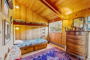 a bedroom with a bed in a wooden cabin at Thayer House in Sea Ranch