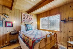 a bedroom with a bed in a wooden room at Thayer House in Sea Ranch