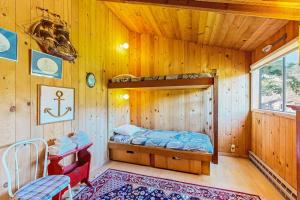 a bedroom with a bunk bed in a wooden cabin at Thayer House in Sea Ranch