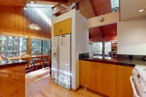 a kitchen with a refrigerator and a dining room at Longwell House in Sea Ranch