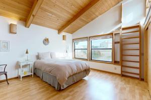 a bedroom with a bed and a large window at Double R in Gualala