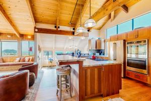 a kitchen and living room with wooden ceilings at Cadwalader House in Sea Ranch +51 photos