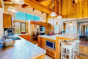 a large kitchen with wooden cabinets and a large island at Cadwalader House in Sea Ranch