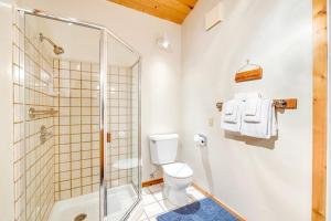 a bathroom with a toilet and a glass shower at Casa Contenta in Gualala +33 photos