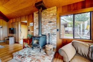 a living room with a woodburning stove in a house at Comstock Retreat in Sea Ranch