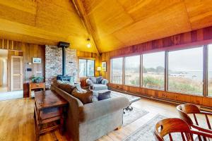 a living room with a couch and a table at Comstock Retreat in Sea Ranch